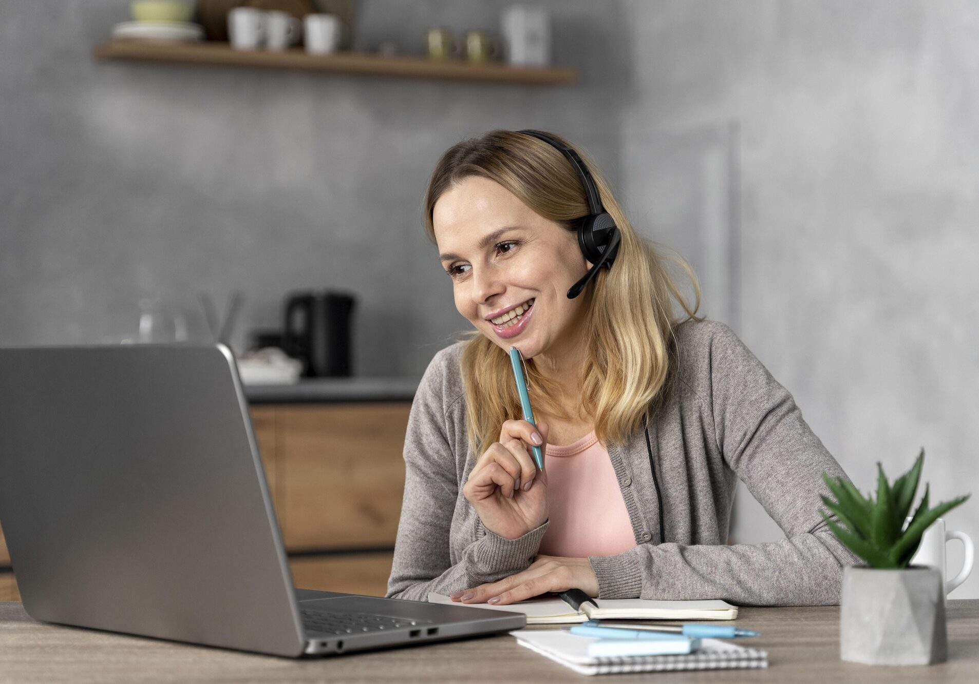 woman-with-headset-working-laptop